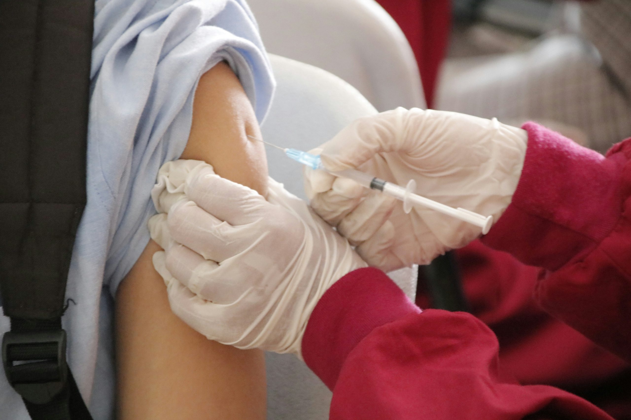 Healthcare professional administering the BCG (TB) vaccine to an infant.